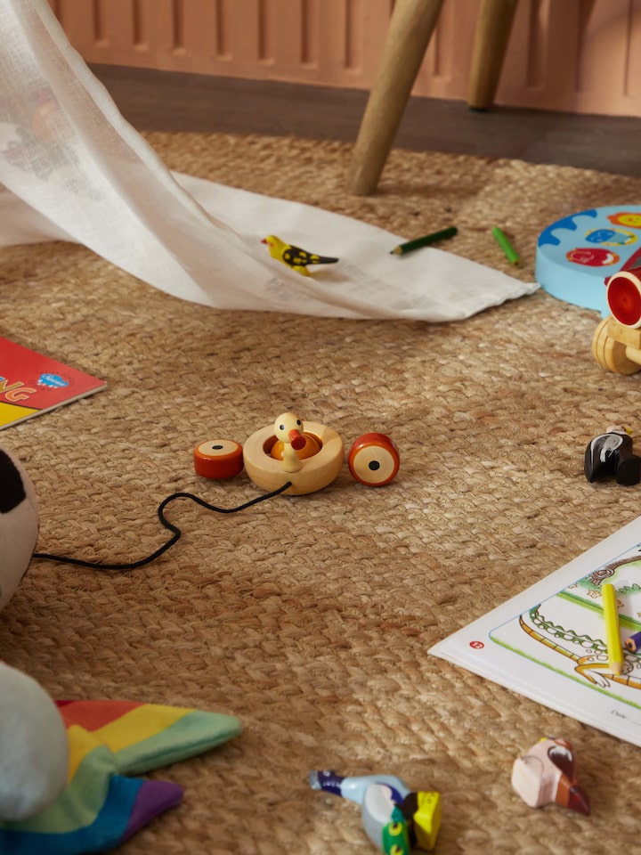 Side view of Channapatna Ivory Wood Duby Duck Toy, showing the shape and subtle color tones of the toy