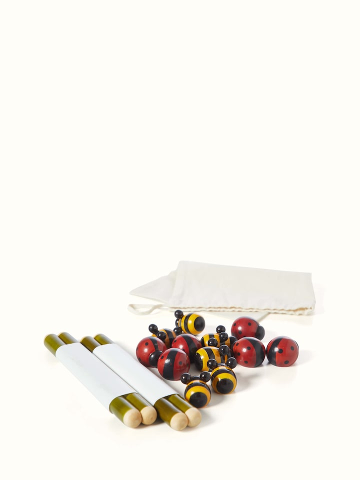 Detailed view of Channapatna ivory wood tic-tac-toe game focusing on the intricate carvings and smooth texture