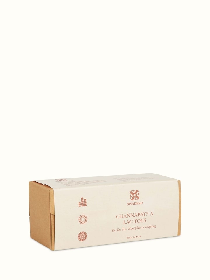 Angled view of Channapatna ivory wood tic-tac-toe game highlighting the three-dimensional design and elegant finish