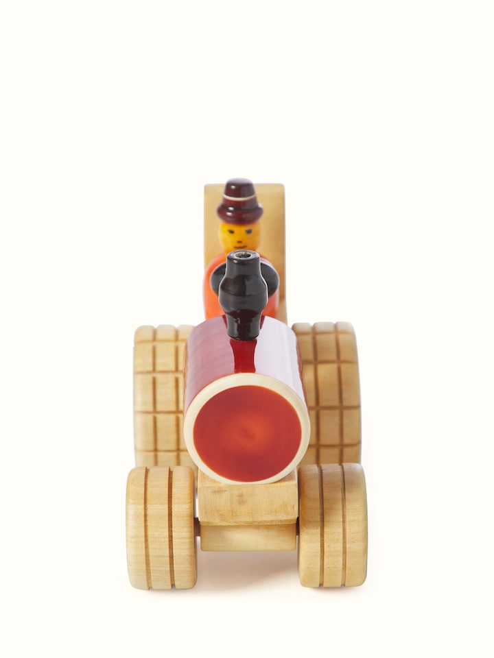 Front view of Channapatna ivory wood tractor toy in red color showcasing its traditional craftsmanship