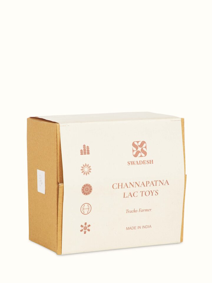 Detailed view of Channapatna ivory wood tractor toy in red color showcasing the craftsmanship and design elements
