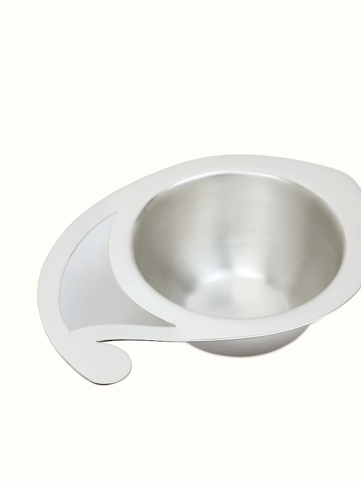 Angled view of Silver paisley diya, emphasizing its intricate design and gleaming surface.