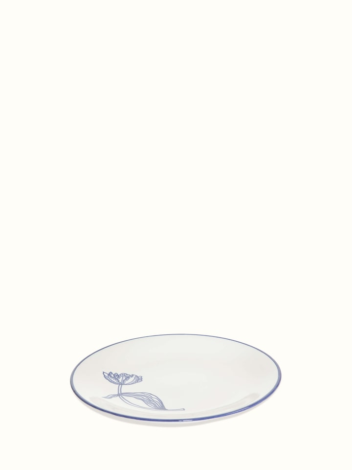 Angled view of white and blue Khurja pottery ceramic dinner plates, showcasing their artistic design and high-quality finish.