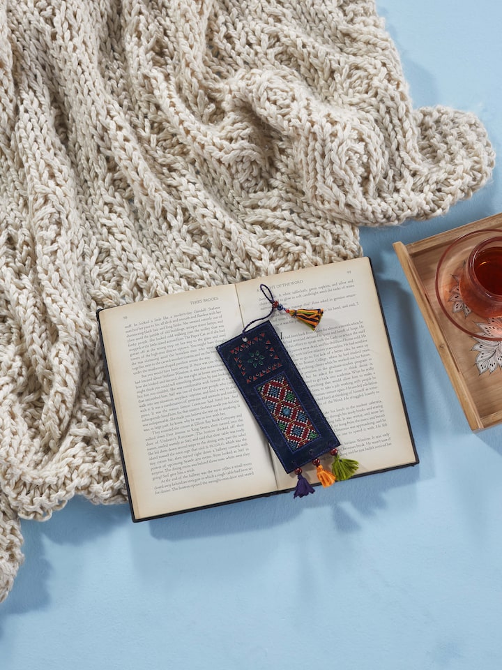 Close-up of Kutch embroidery leather bookmark in blue, highlighting the detailed embroidery work.