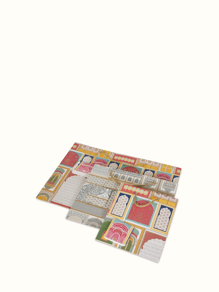 Angled view of Handmade paper gift bags white (3 pcs) showing their elegant form.