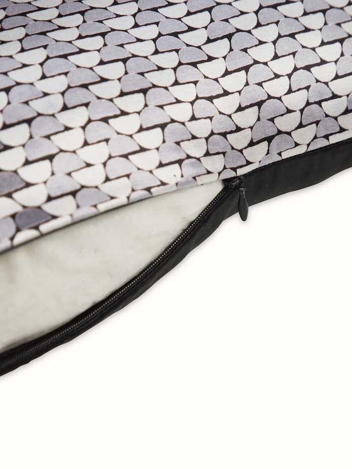 Angled view of Sanganeri print design in geometric motifs on grey cushion cover.