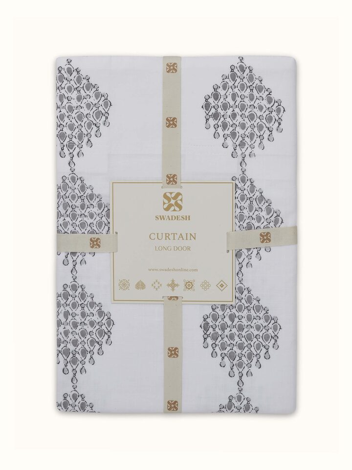 Angled view of Rambagh White Modern Geo Diamond Cotton Sanganeri Block Printed Curtain (9 ft) displaying the modern design and print details.