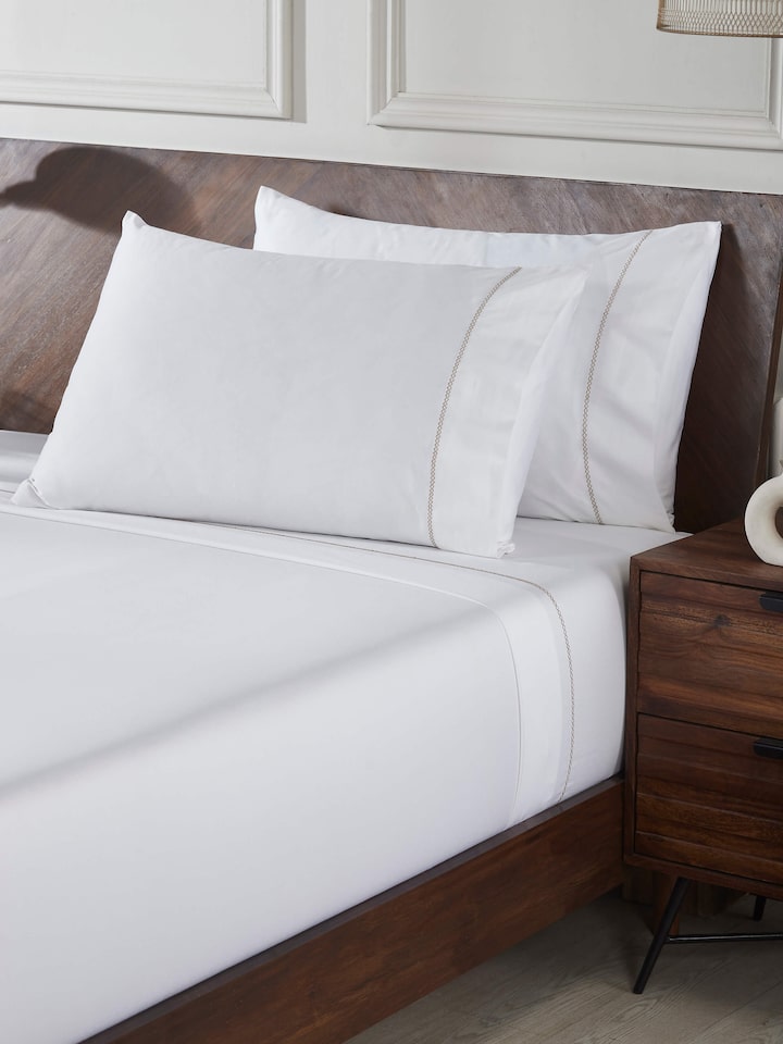 Styled view of Rambagh Green Stripe Cotton Hand Embroidery King-size Bedsheet Set styled on a table or bed setting, from a different angle