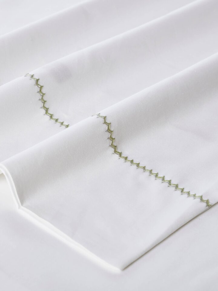 Detail view of Rambagh Green Stripe Cotton Hand Embroidery King-size Bedsheet Set highlighting the fabric texture and embroidery detail, in an alte...