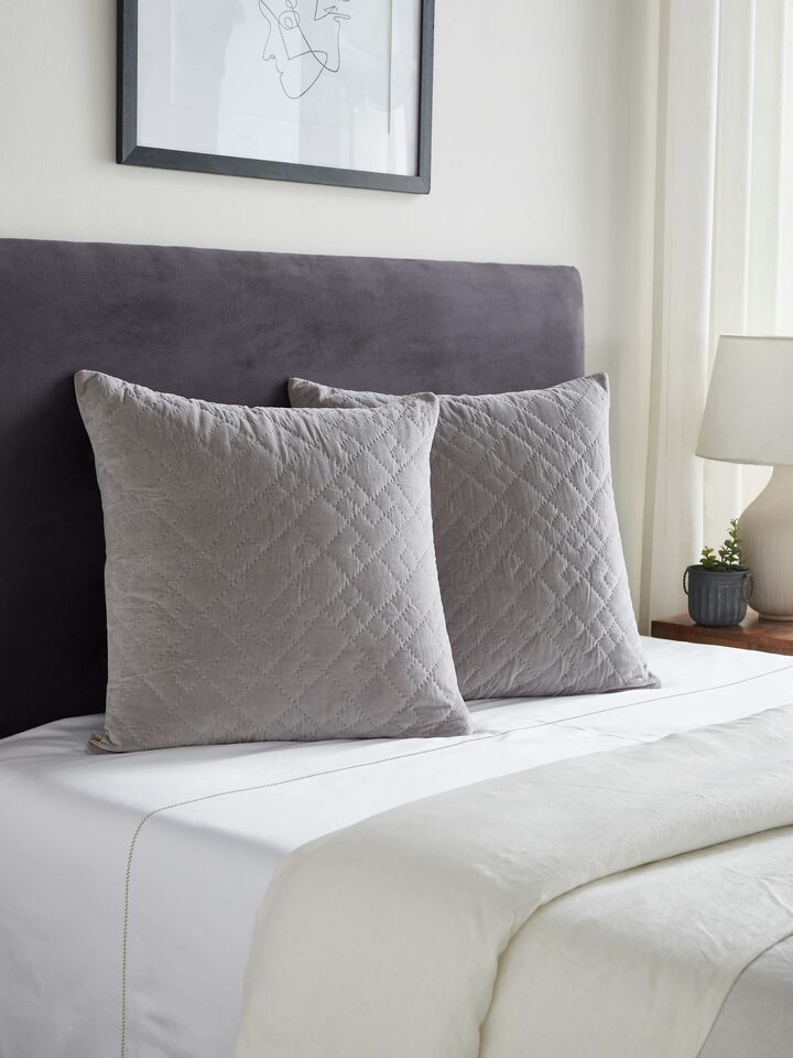 Side view of Shivranjini light grey solid textured cotton razai embroidered euro shams, highlighting the design