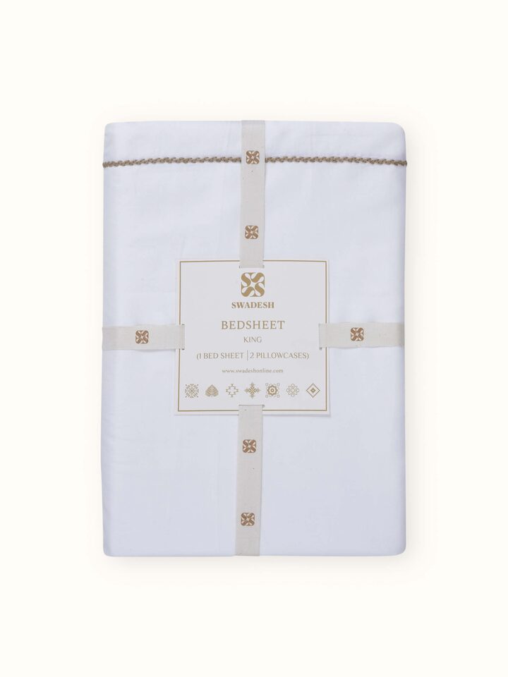 Shivranjini beige stripe cotton hand embroidered bedsheet king set folded, displaying its texture and detailed hand embroidery.
