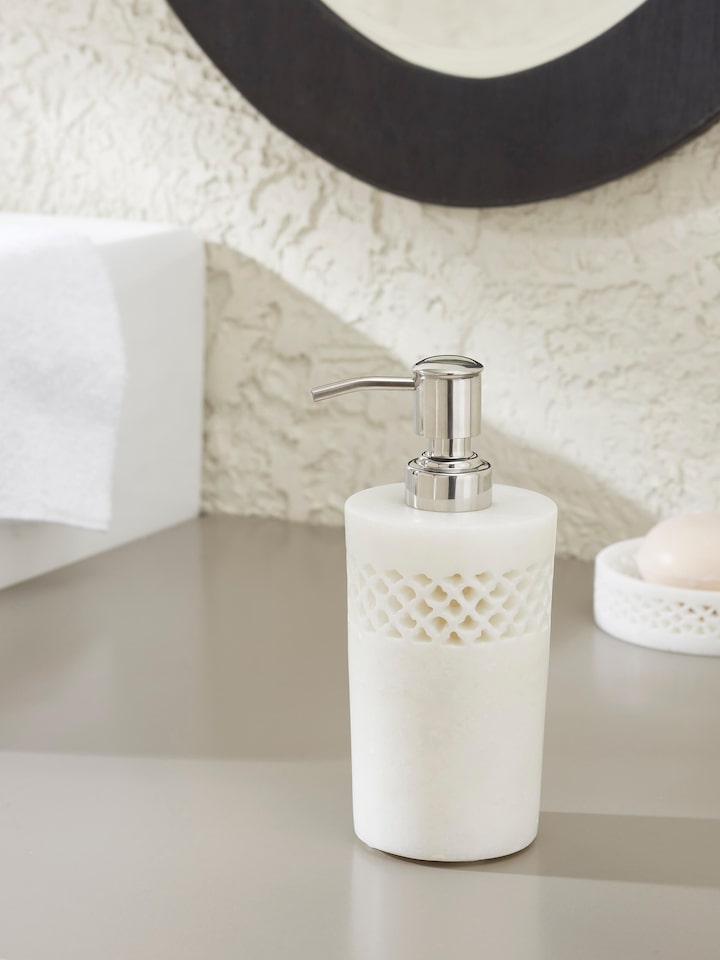 Side view of Carved Ambaji white marble soap dispenser showing detailed design.