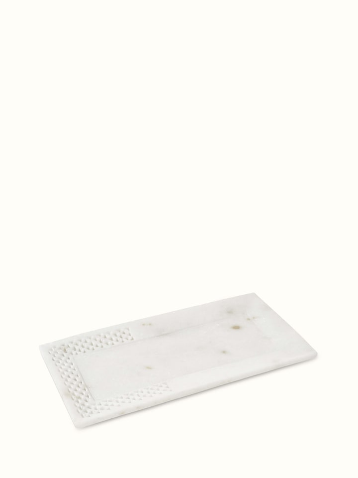 Angled view of Carved Ambaji marble bath tray in white, focusing on the elegant design and fine details.