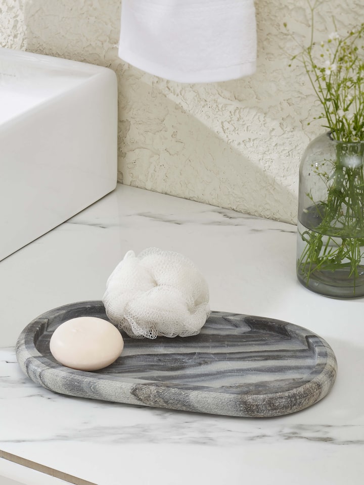 Side view of carved marble bath tray in grey color highlighting its detailed carving