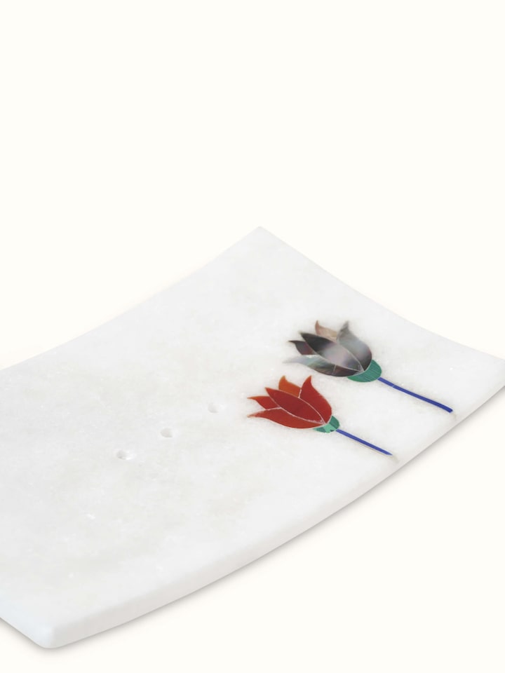 Close-up of carved Ambaji white marble lotus soap dish highlighting the marble's intricate details.