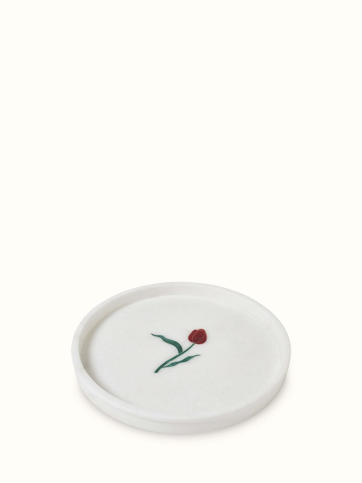 Front view of white carved Ambaji marble bath tray with detailed craftsmanship