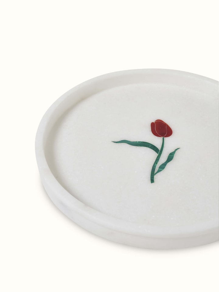 Top view of white carved Ambaji marble bath tray showcasing fine details