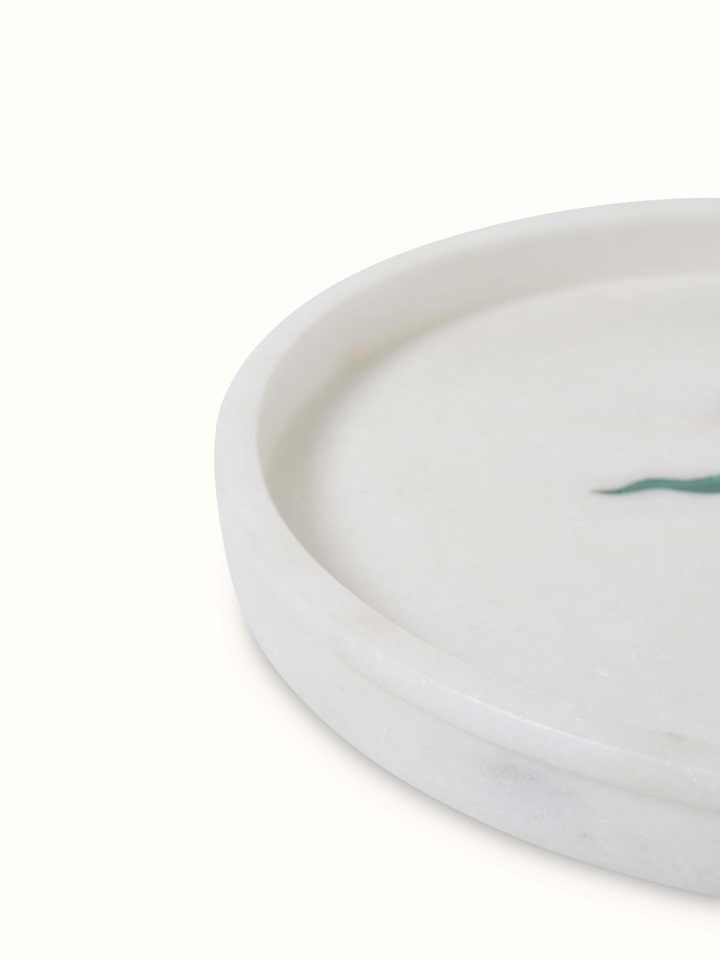 Close-up view of white carved Ambaji marble bath tray with elegant carvings