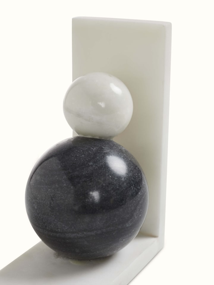 Close-up of carved marble bookend in white color highlighting intricate carving details
