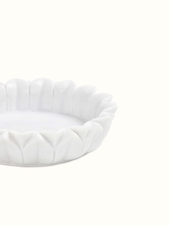 Detailed view of Glossy Carved Marble Urli emphasizing its smooth finish.