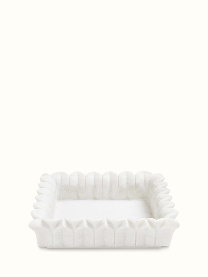 Front view of rectangular carved marble urli with detailed design