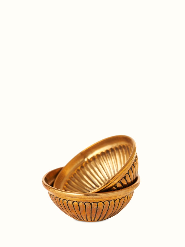 Close-up view of Polished brass Gajanan pooja thali focusing on intricate detailing and craftsmanship.