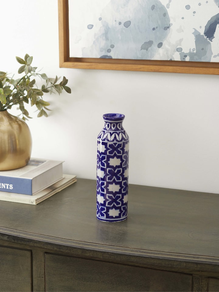 Side view of Blue pottery ceramic bud vase emphasizing the pottery’s unique design and blue color.