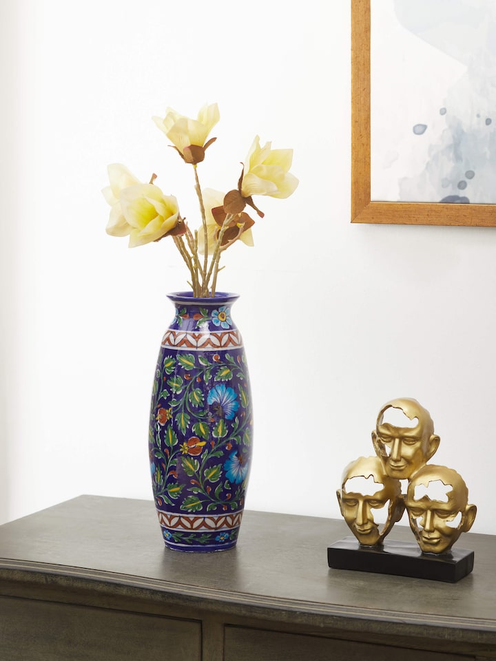 Side view of Glossy blue pottery ceramic table vase highlighting the smooth texture and rich color
