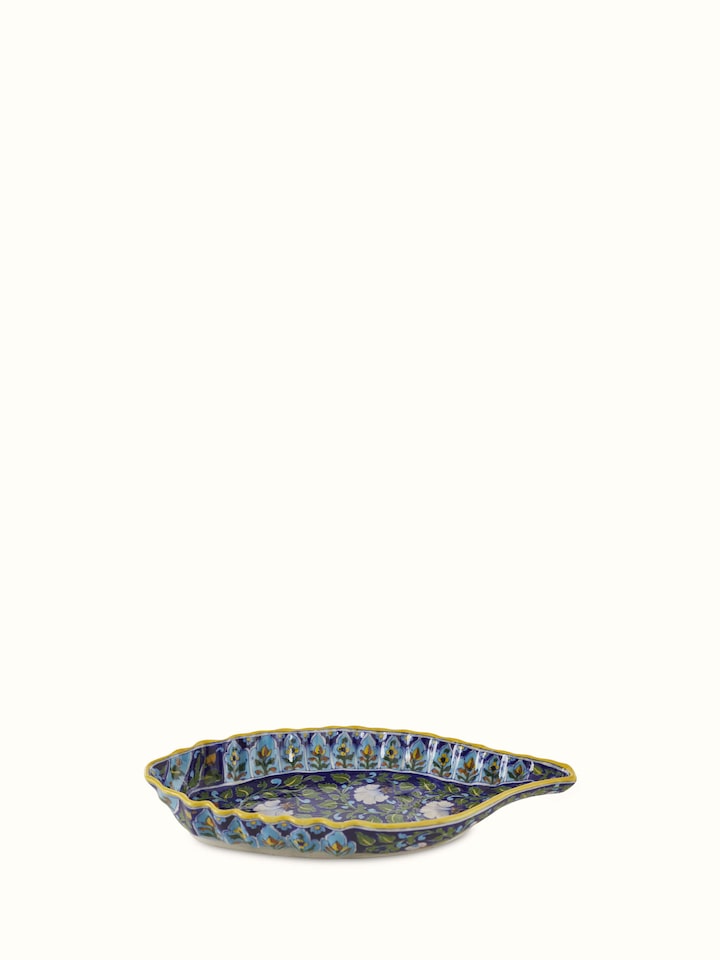 Close-up of blue pottery ceramic conch shell planter, highlighting its intricate design and rich blue glaze.