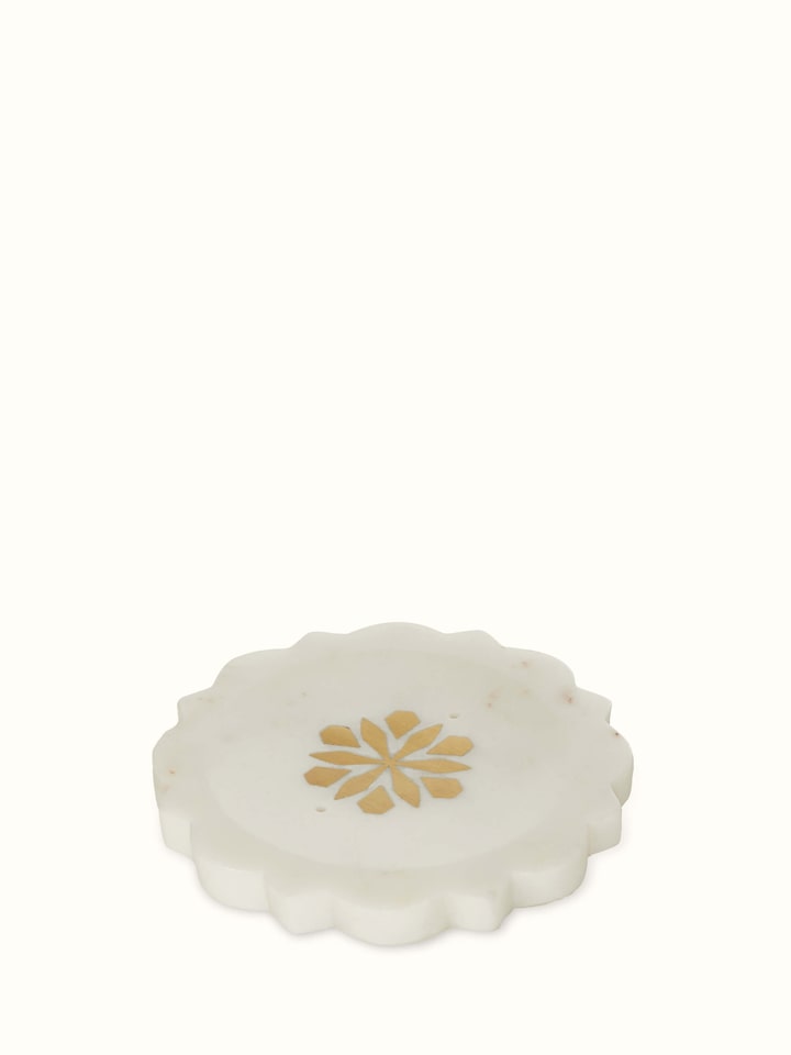 Close-up of stone-worked marble and brass soap dish in gold color, highlighting its luxurious finish and intricate design.