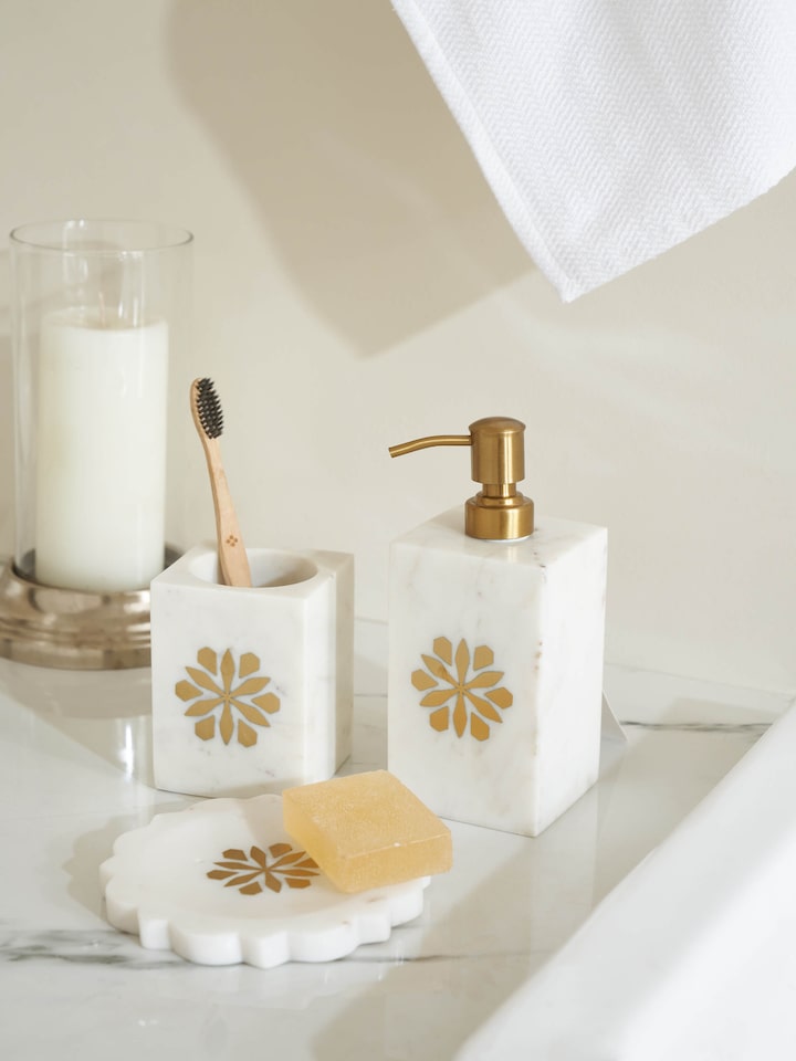 Side view of stone-worked marble and brass soap dish in gold color, featuring its elegant marble patterns and brass detailing.
