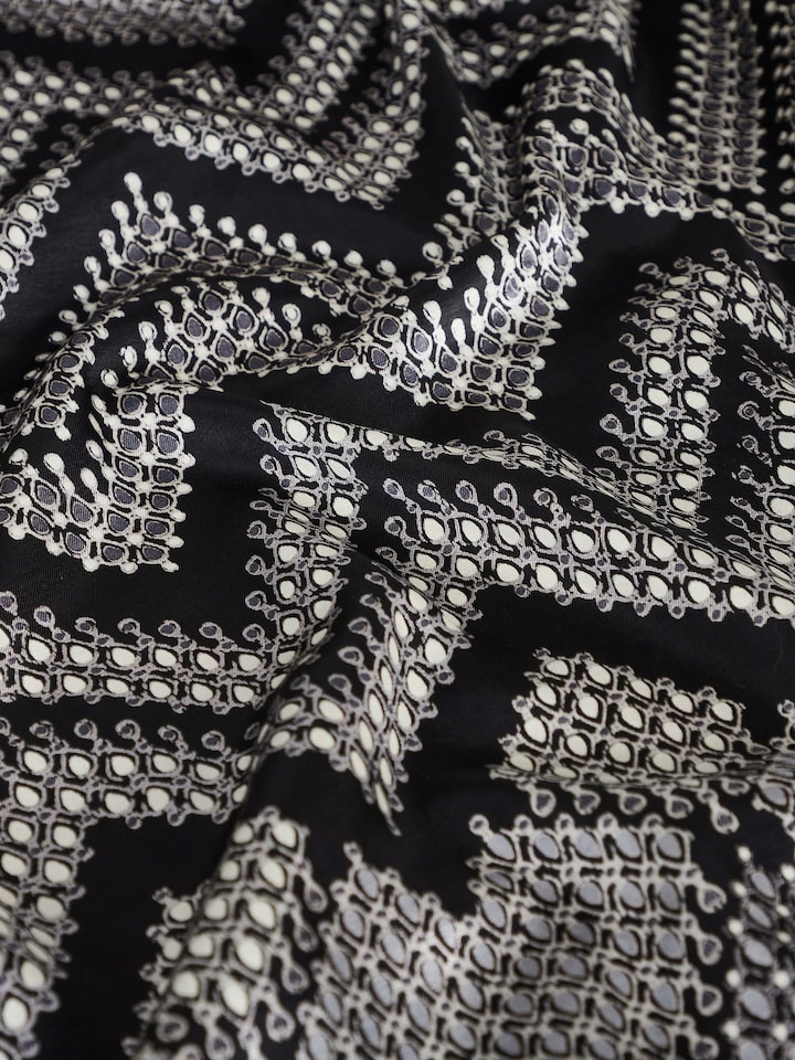 Rambagh geometric viscose cotton blend Sanganeri block printed double bedspread set, draped over a bed with matching pillow covers.