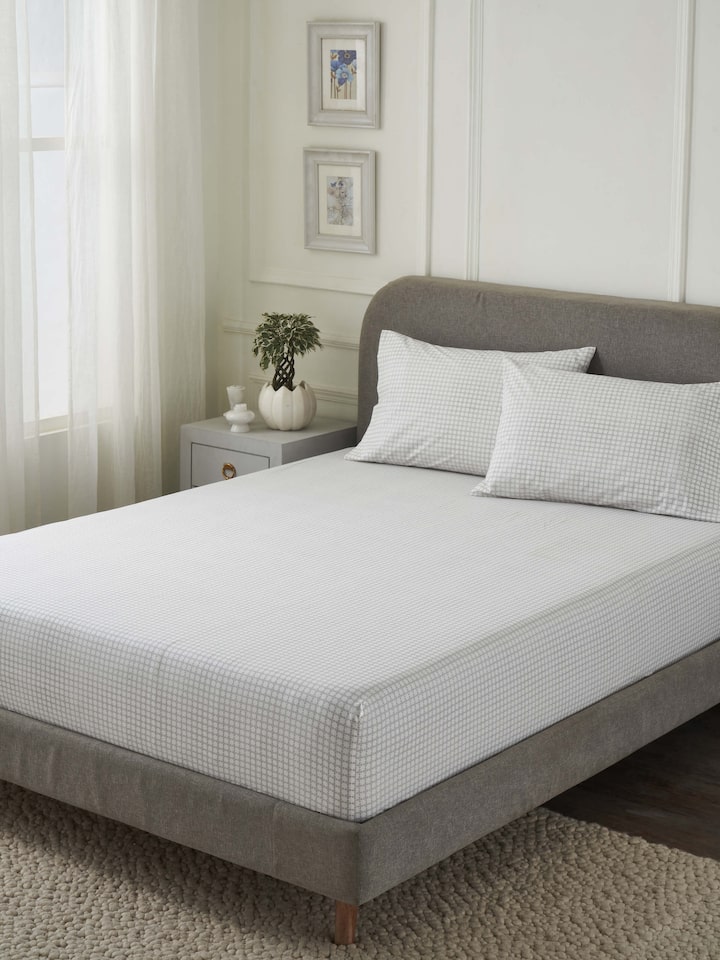 Close-up of the Pratidin grey grid cotton king fitted bedsheet set, highlighting the Sanganeri block print and soft texture