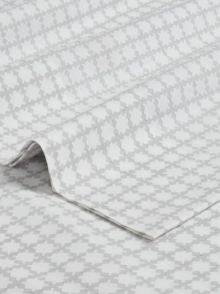 Perspective view of Pratidin grey grid cotton Sanganeri block printed queen fitted bedsheet set showcasing its design and fit.