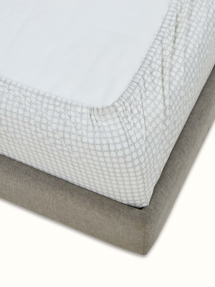 Side view of Pratidin grey grid cotton Sanganeri block printed queen fitted bedsheet set highlighting the fabric texture and grid pattern.