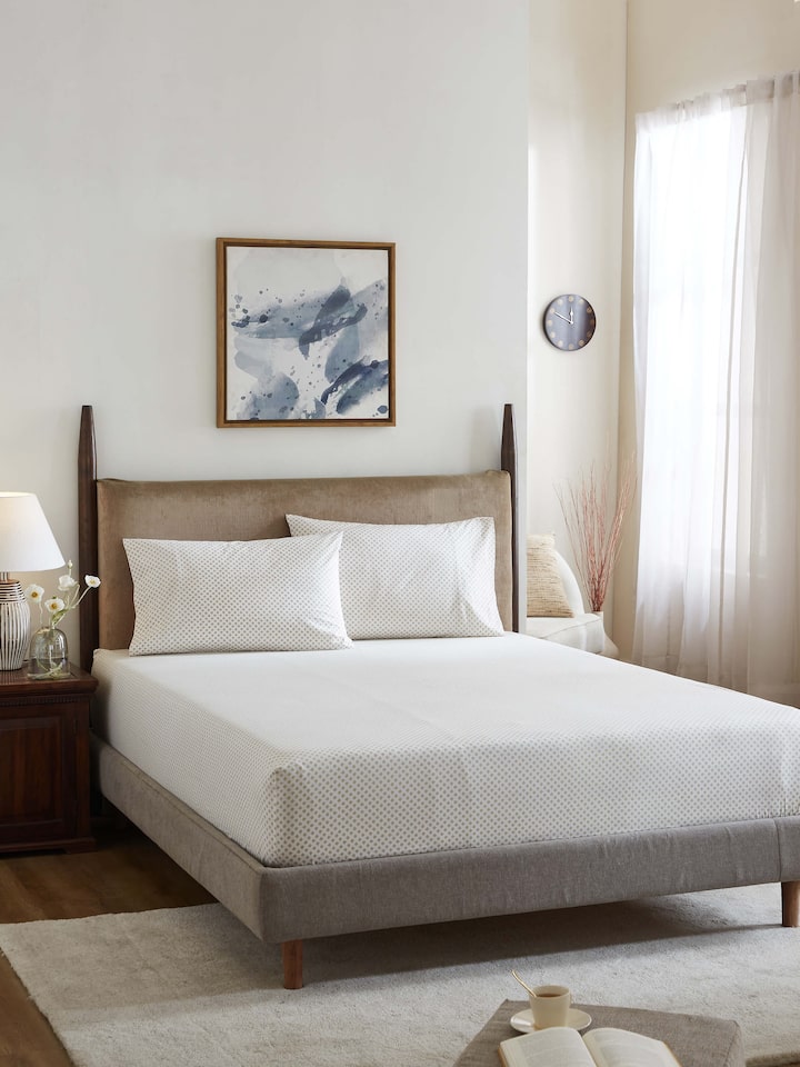 Front view of Pratidin beige scallop cotton Sanganeri block printed queen fitted bedsheet set highlighting its elegant design and texture.