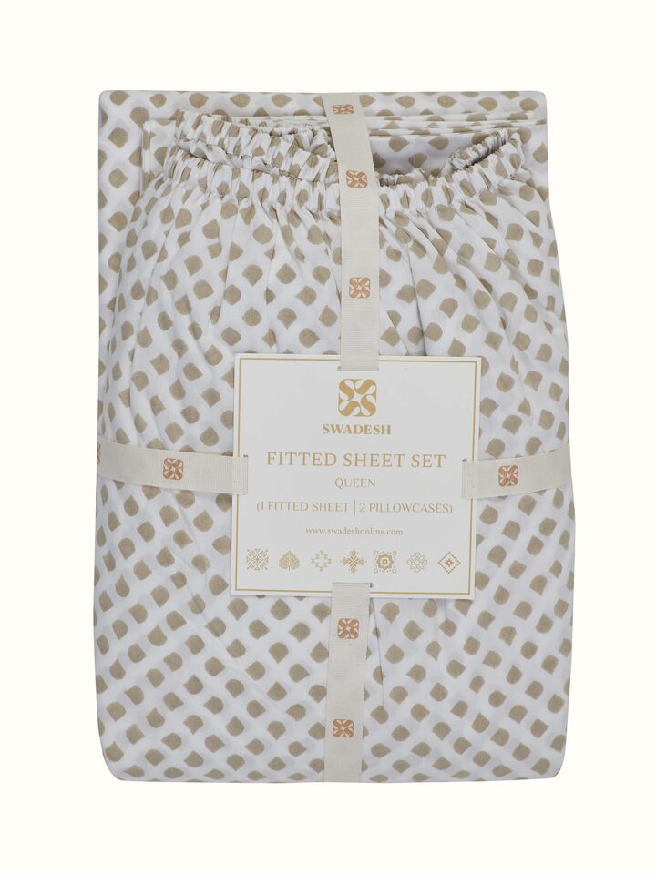 Angled view of Pratidin beige scallop cotton Sanganeri block printed queen fitted bedsheet set displaying the full set layout and scallop design.