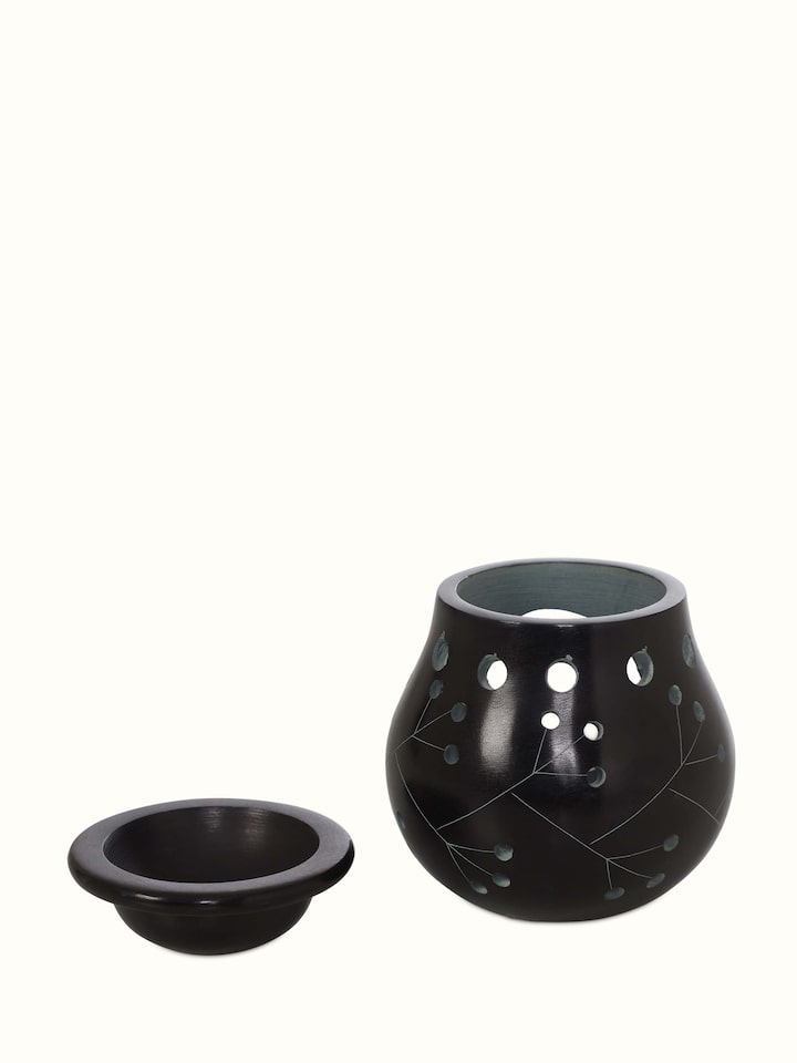 Angled view of Carved Stone Diffuser in Black Color, showcasing the three-dimensional aspect and decorative carvings