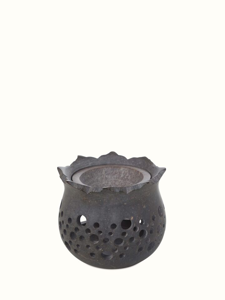 Detailed view of hand-carved stone diffuser.