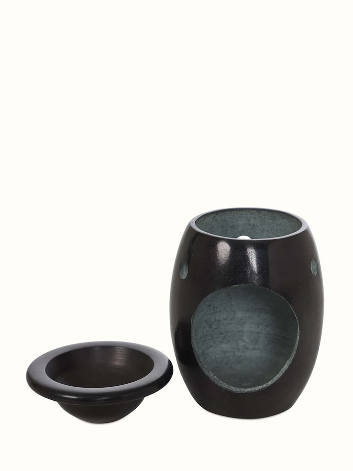 Carved stone diffuser with intricate patterns, offering a decorative touch and functionality for aromatherapy.