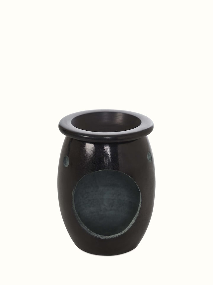 Detailed close-up of the carved stone diffuser, highlighting the fine carvings and stone texture.