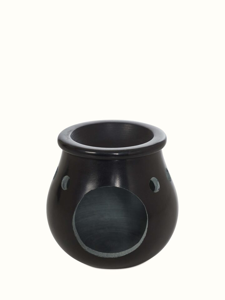 Close-up of carved stone diffuser in black color, showcasing the fine craftsmanship and texture of the stone