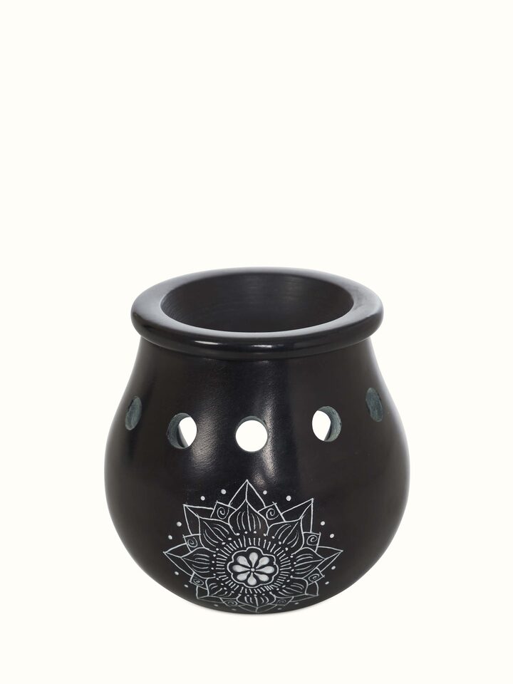 Detailed view of carved stone diffuser in black color, focusing on the intricate patterns and high-quality material