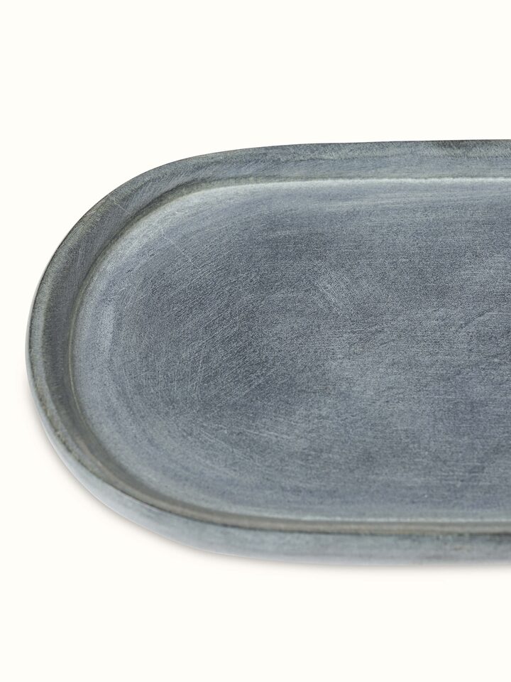 Side view of natural carved stone bath tray, emphasizing the craftsmanship and stone's natural finish.