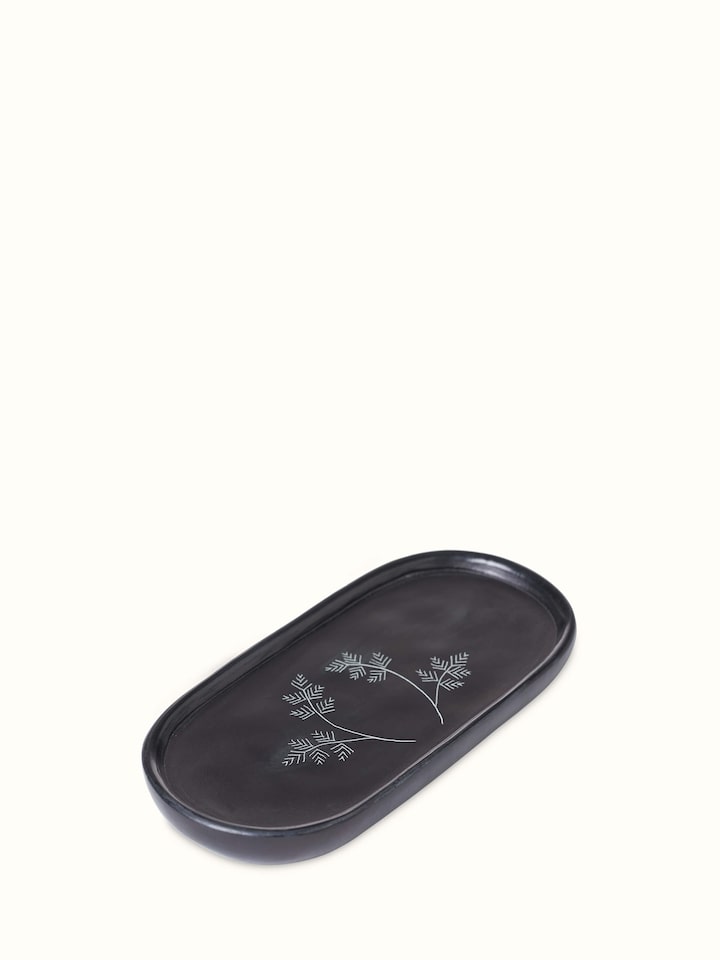 Angled view of Carved stone bath tray showing intricate carvings and durable stone finish