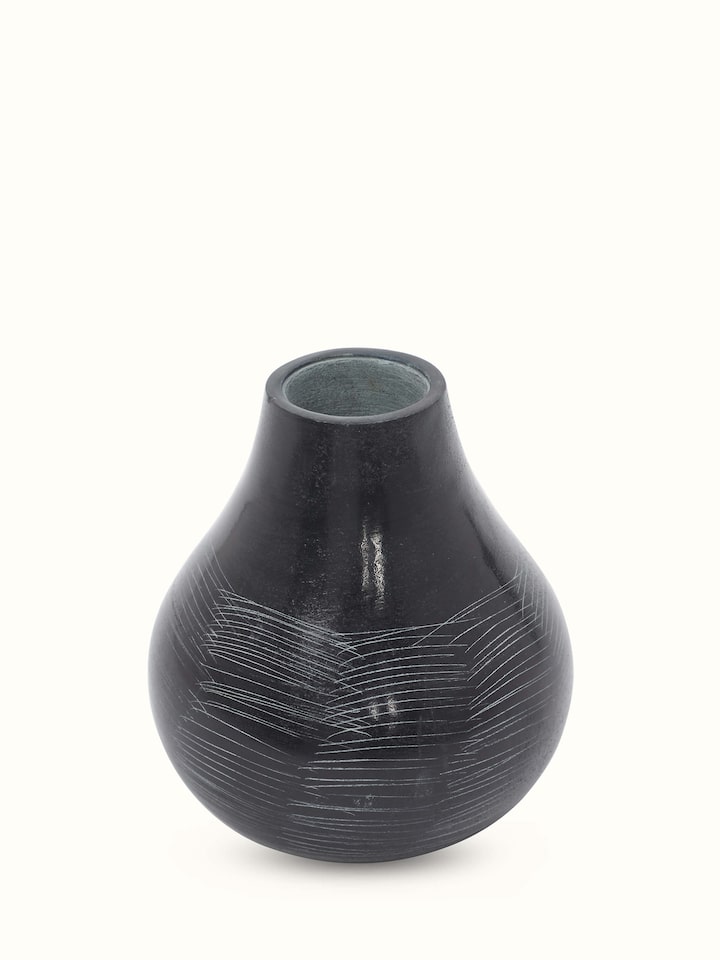Front view of carved stone vase in black color with elegant and refined design