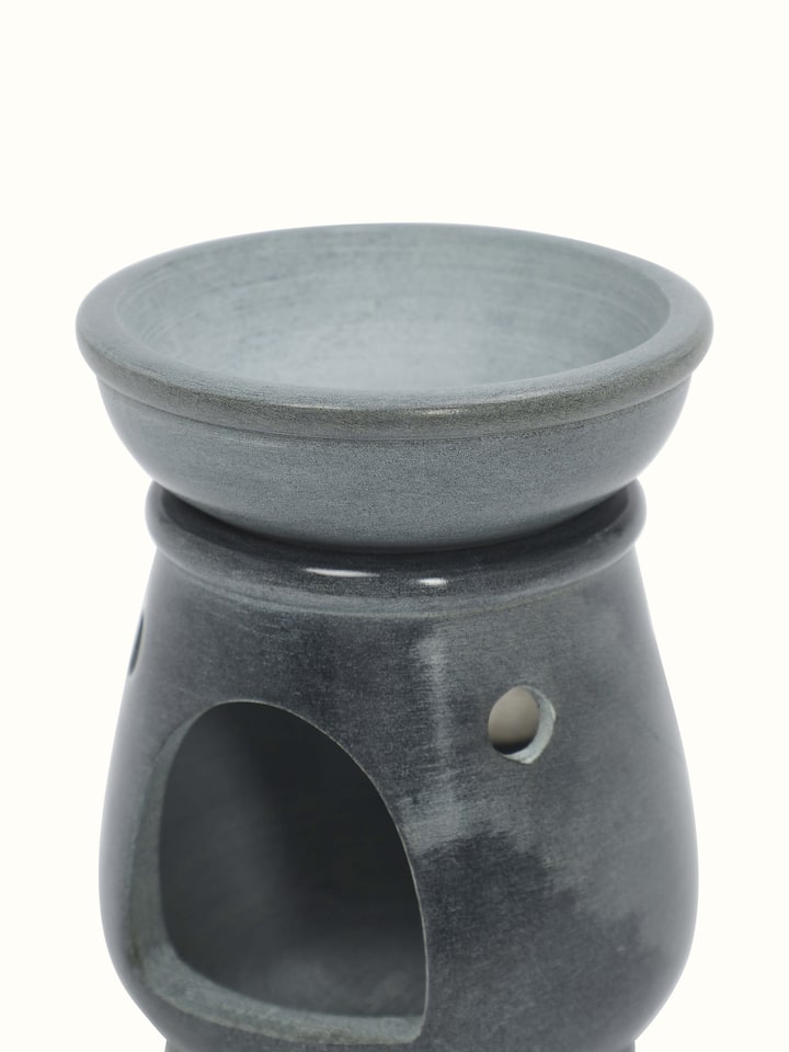 Angle view of Traditional carved stone diffuser emphasizing its handcrafted design.