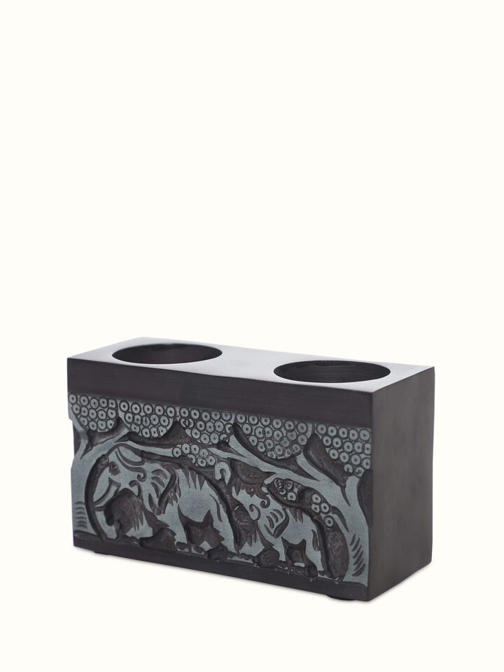 Angled view of Transitional Carved Stone Tea Light Holder, showcasing its shape and the detailed carving from a different perspective.