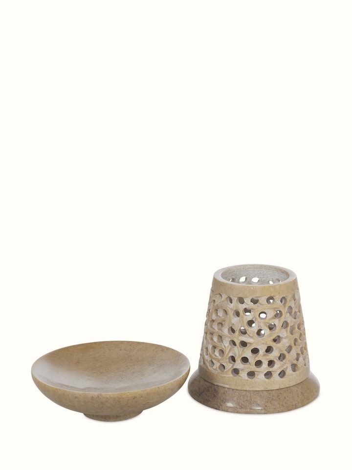 Angle view of polished carved stone diffuser showing the smooth transitional finish and artistic design