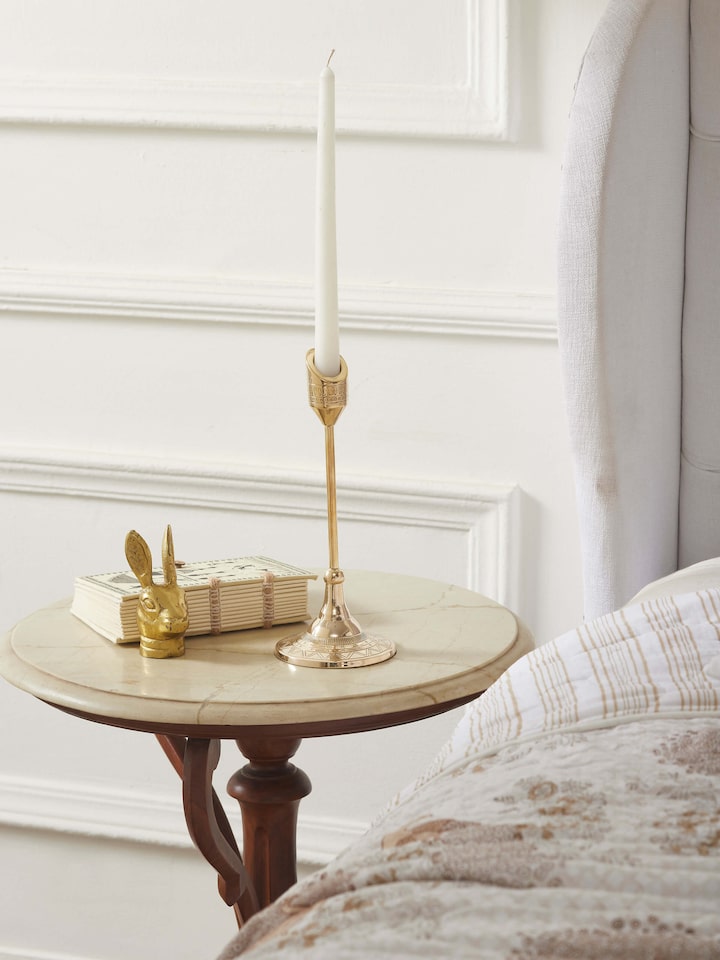 Close-up view of natural brass candle stand, showcasing its detailed craftsmanship.